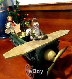 German Santa Claus with Feather Tree, Riding a Green Loofah Airplane with Toys