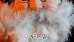 Vintage paper mache Santa Claus head blue eyes feathers